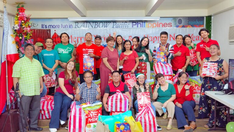 Officers and staff of the Rainbow Pacific Philippines pose with their gifts of groceries and 25 kg sack during their traditional Christmas Party.