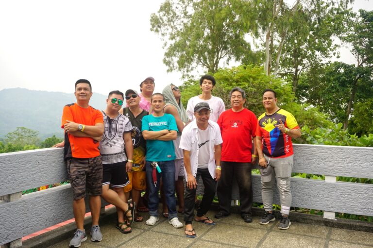 The men's group striking a pose with the stunning Tanay view.